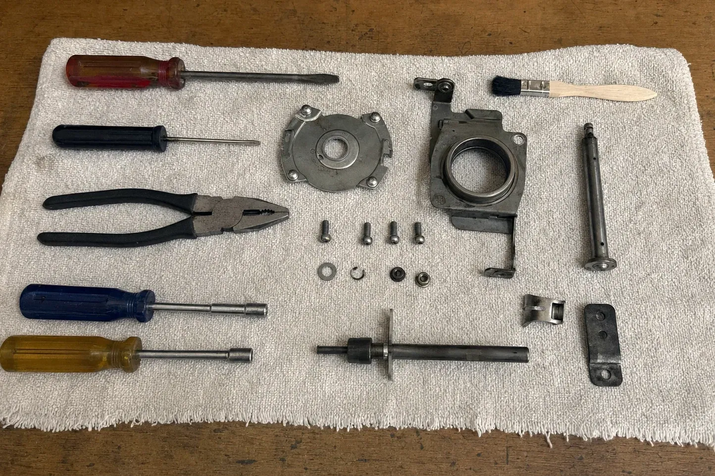 Bearing housing, shaft, screws and hand tools laid on cloth